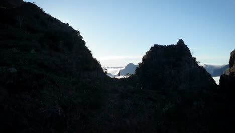 young-woman-watches-over-mountain-landscape,-standing-on-mountain-ridge,-feminism-concept