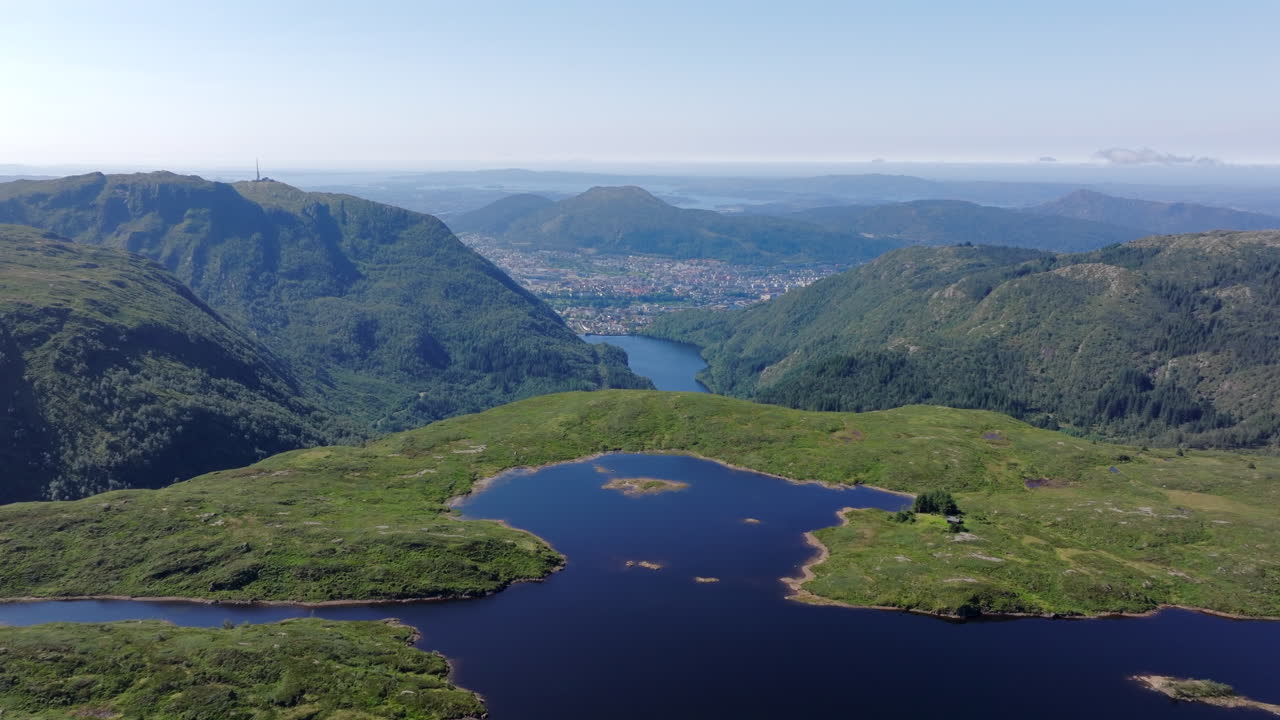 Aerial footage soaring above Langelivatnet on Vidden, combining tranquil alpine scenery with panoramic views of Bergen city