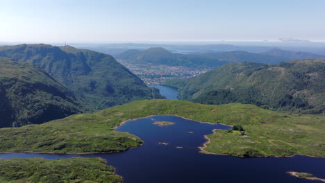 aerial footage soaring above langelivatnet on vidden, combining tranquil alpine scenery with panoramic views of bergen city