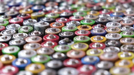 close up top view of rows of aa energy batteries abstract background of colorful batteries close up top view of rows of aa energy batteries abstract background of colorful batteries several batteries are standing nearby lots of aa batteries toxic pollution of the planet earth