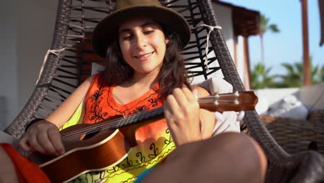 young hipster woman playing ukulele guitar