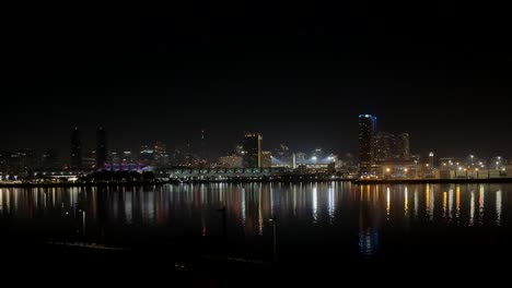 Downtown-skyline-illuminated-at-night,-reflected-in-San-Diego's-Coronado-Bay