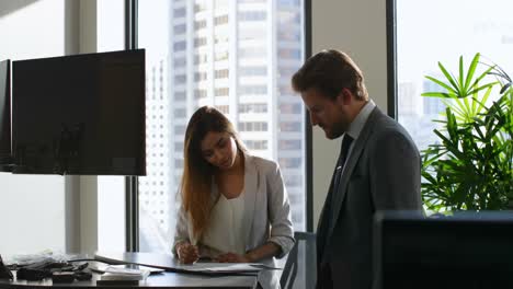 Business-people-discussing-over-documents-in-office-4k