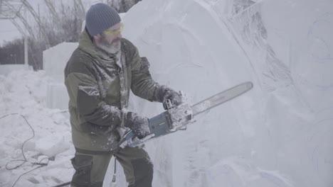 ice sculptor carving a large ice block