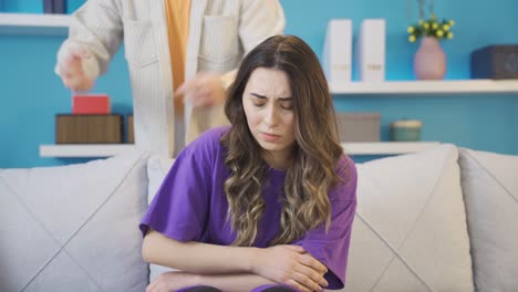 cowardly and weak young woman who is subjected to verbal violence by her husband or lover looks at camera.