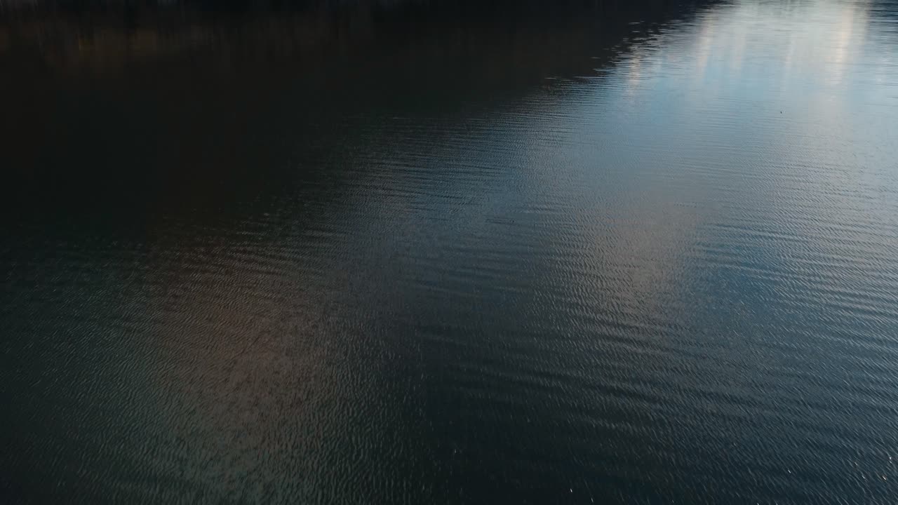 Aerial above lake Endine in Italy, tilt up reveals breathtaking landscape