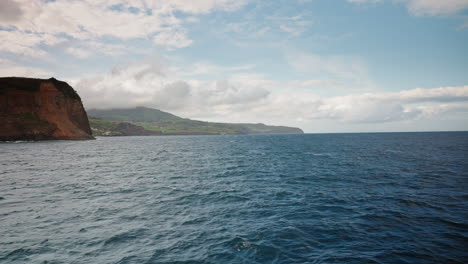 Approaching-the-coasts-of-Faial-island-in-the-Azores-by-boat,-Portugal