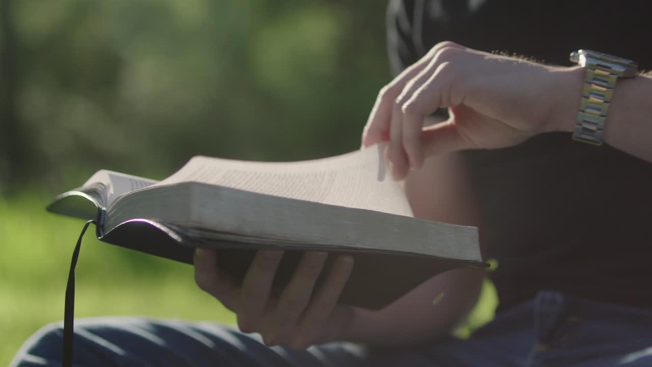 Man reading a book outdoors