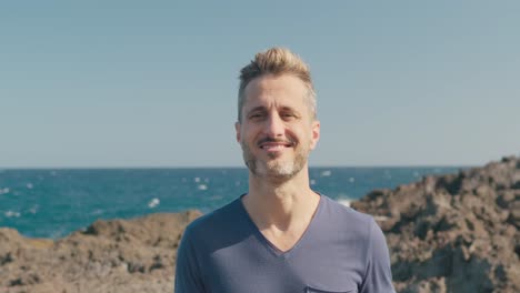 male tourist walking on volcanic seashore