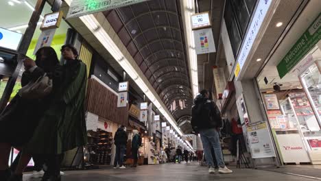 pedestrians walking through a covered shopping arcade