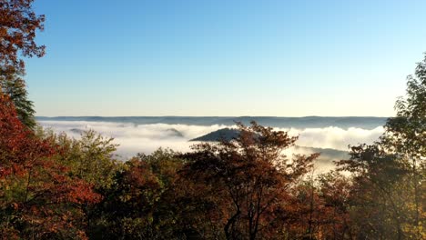 Time-lapse-of-the-valley-on-an-early-sunrise-morning-as-the-fog-rolls-through-the-low-mountain-range