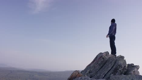 man standing on mountain summit