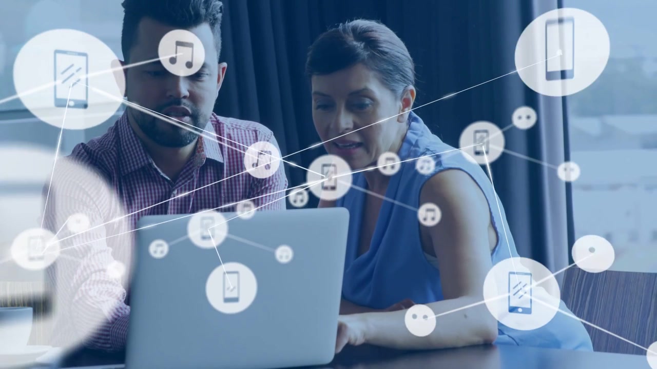 Man pointing and woman touching laptop initiating network overlaying laptop for tech meeting