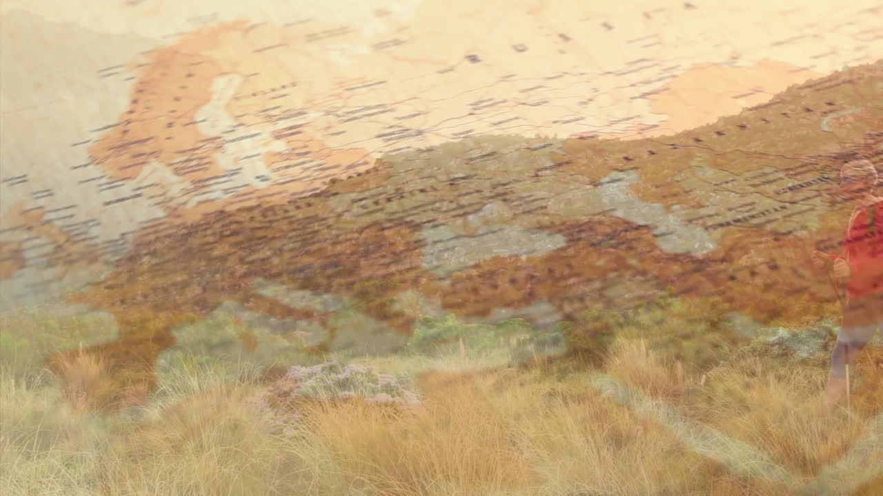 Male hiker striding through mountain meadow, with travel map overlay showing Atlantic Ocean