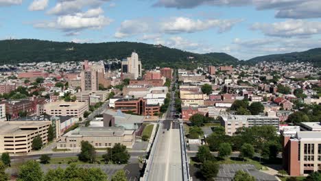 Aerial-pullback,-Reading-PA,-Pennsylvania-USA-United-States-urban-city,-Schuylkill-River,-summer-day-under-beautiful-clouds-and-sky