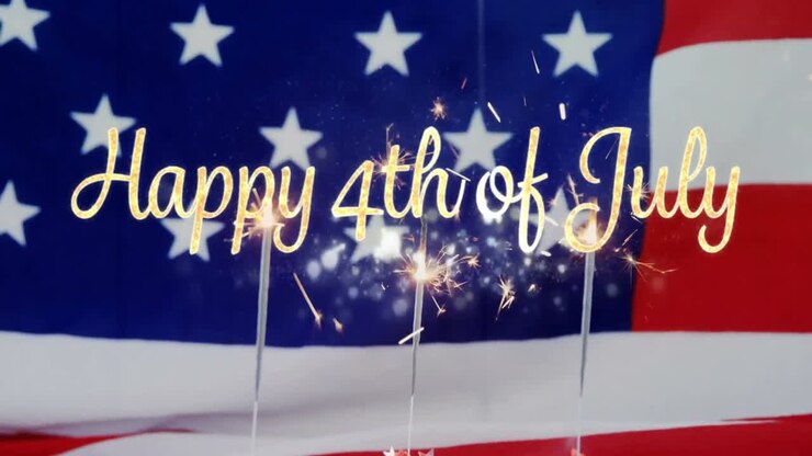 Happy 4th of July text and an American flag with sparkles on cupcakes