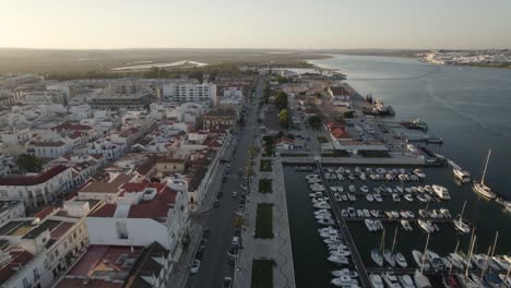 Aerial-pullback-over-marina-on-Guadiana-river,-Vila-Real-de-Santo-Antonio