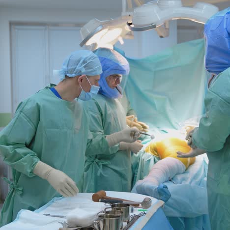 operating room with surgery in progress. medical team performing surgical operation in bright modern operating room