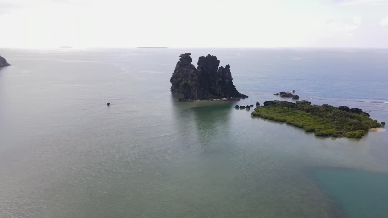 Drone aerial at La Poule in New Caledonia panning on a cloudy day