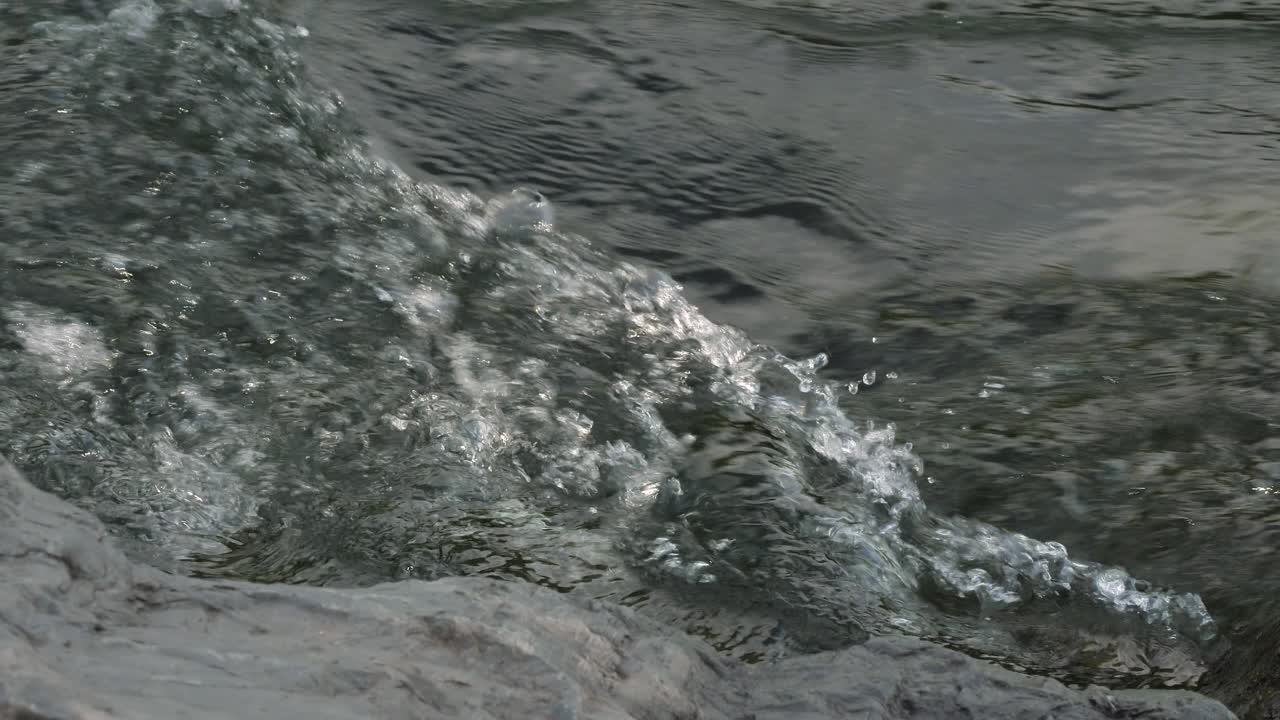Close view of the turbulent waters of the Tumut River in Tumut in the Snowy Mountain Region of Australia, New South Wales.