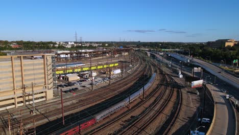 Excelente-Vista-Aérea-De-Las-Vías-Del-Tren-Cerca-De-Una-Autopista-En-Filadelfia,-Pensilvania