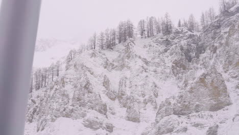 panning camera view from cabin window of skyway going up to mont blanc