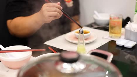 person enjoying meal with dipping sauce