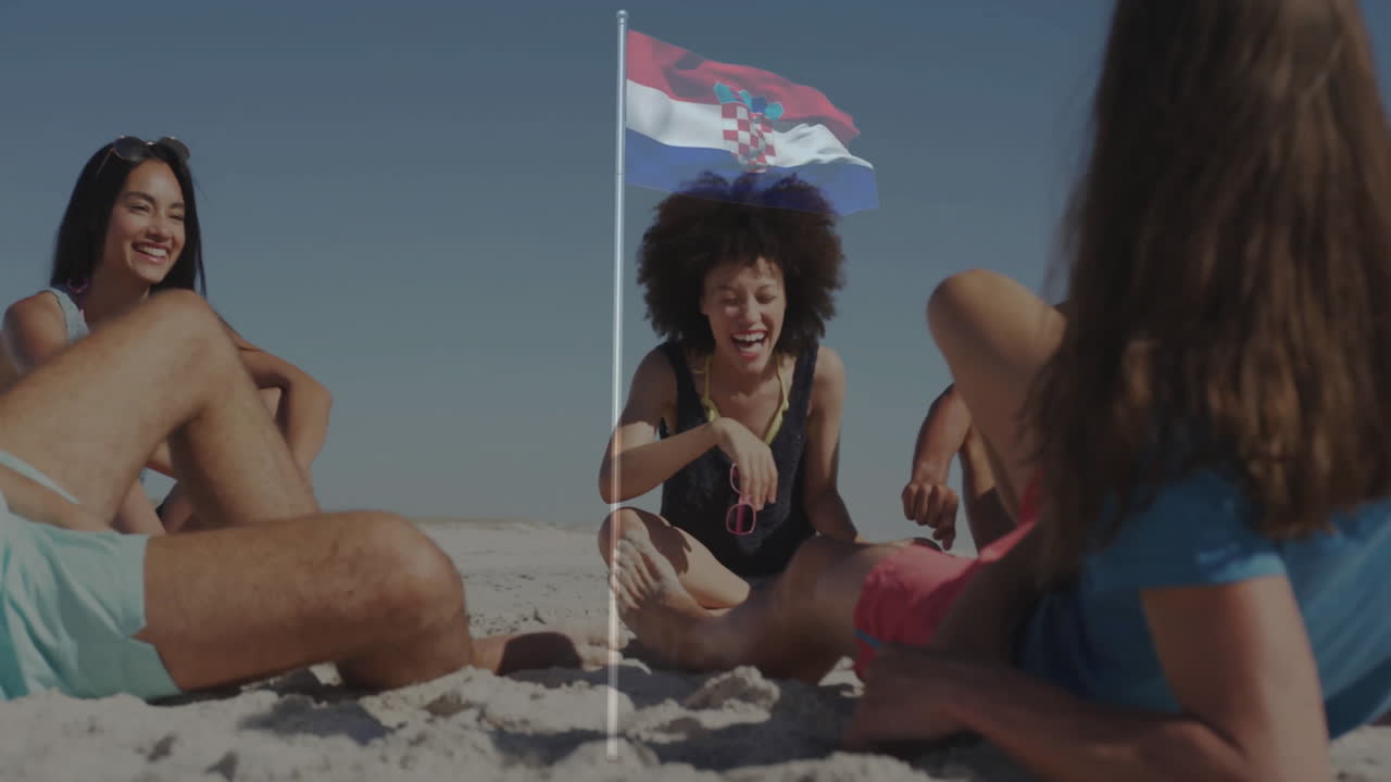 Relaxing on beach, friends with Croatian flag planted in sand, enjoying animation