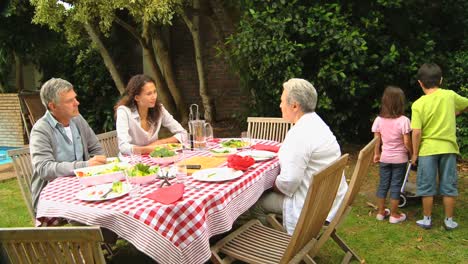 children helping with barbecue lunch in garden