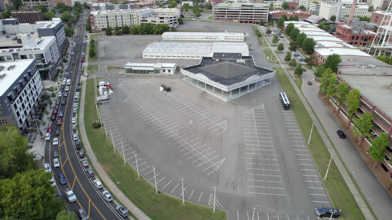 Aerial drone over empty parking lot, abandoned building, downtown city