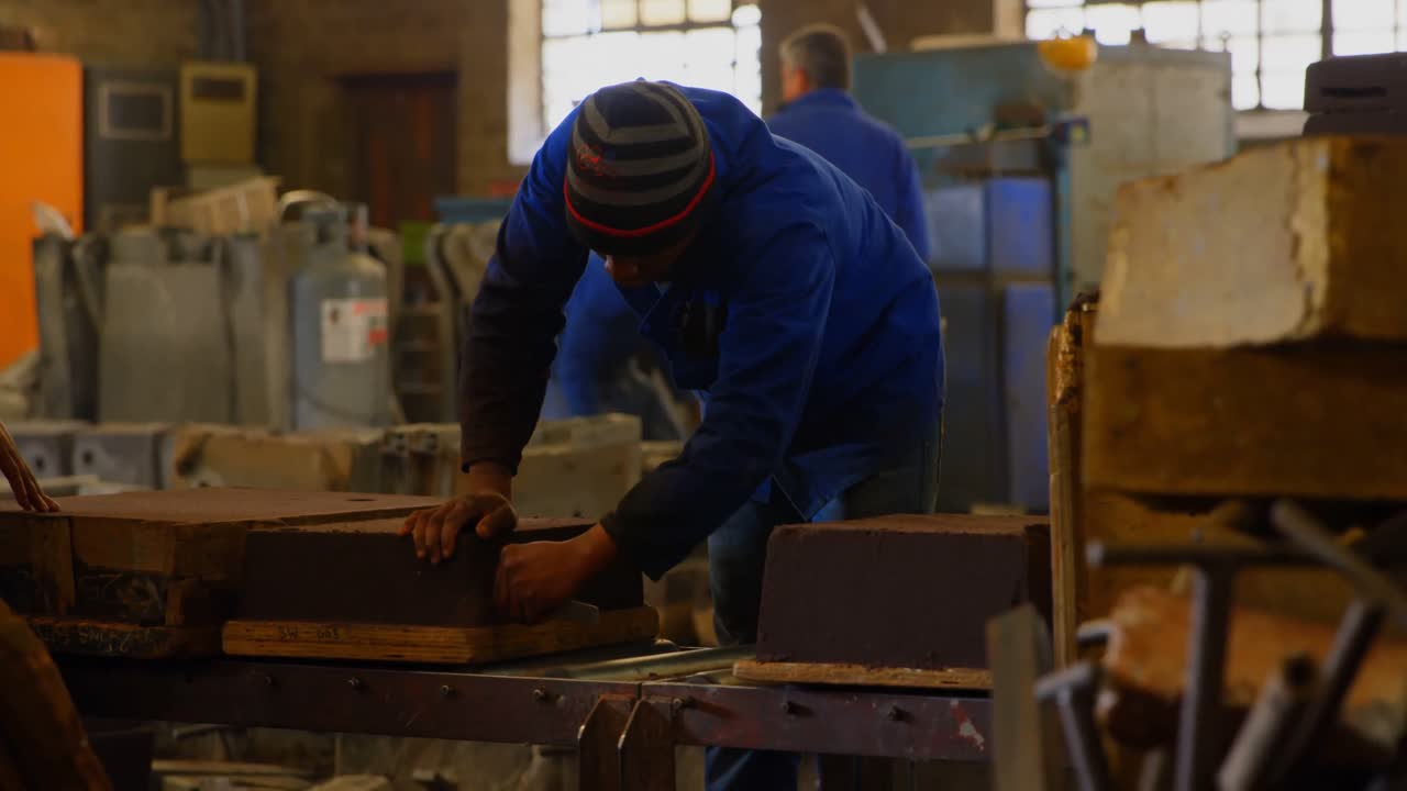 Male worker arranging molds in workshop 4k