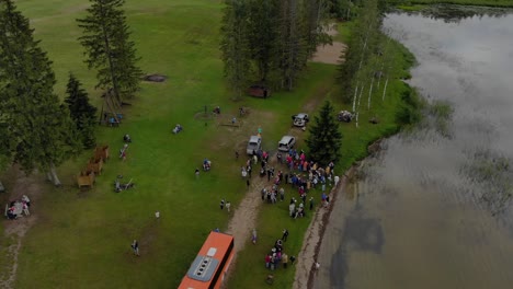 drone flying over a group outdoor picnic near a lake