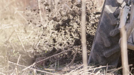 a rototiller works the land, agriculture in sweden, slow motion close up