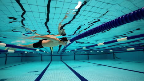 a male swimmer captured underwater in a pool