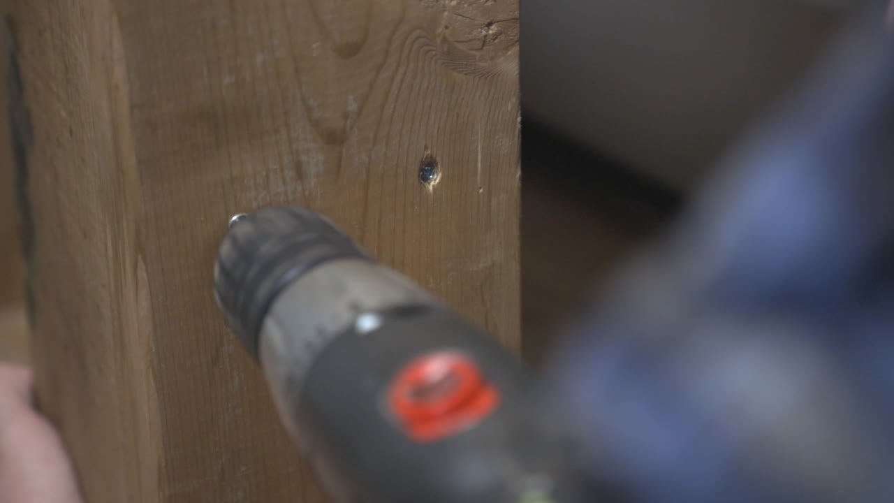 Drilling Screw Into Wood With An Electric Drill - close up