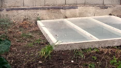 close up of triple concrete window falling on earth ground and not breaking