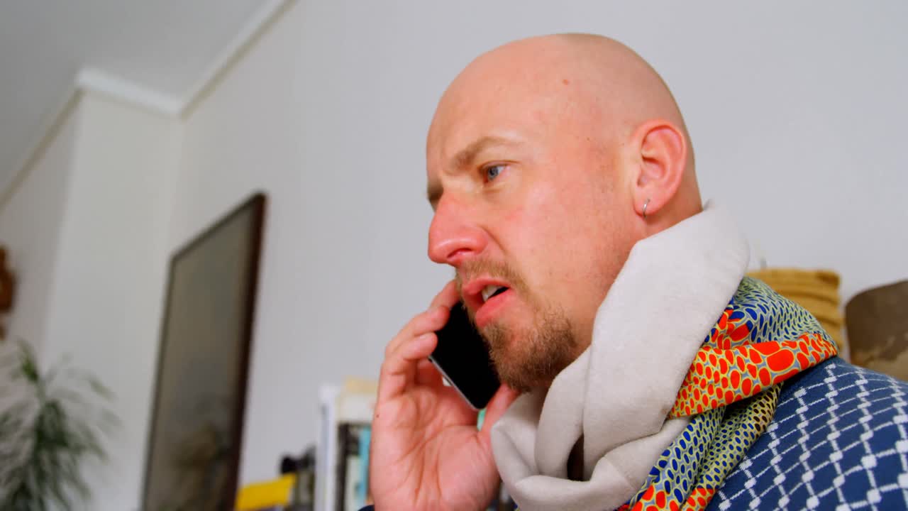 Man talking on mobile phone at home 4k