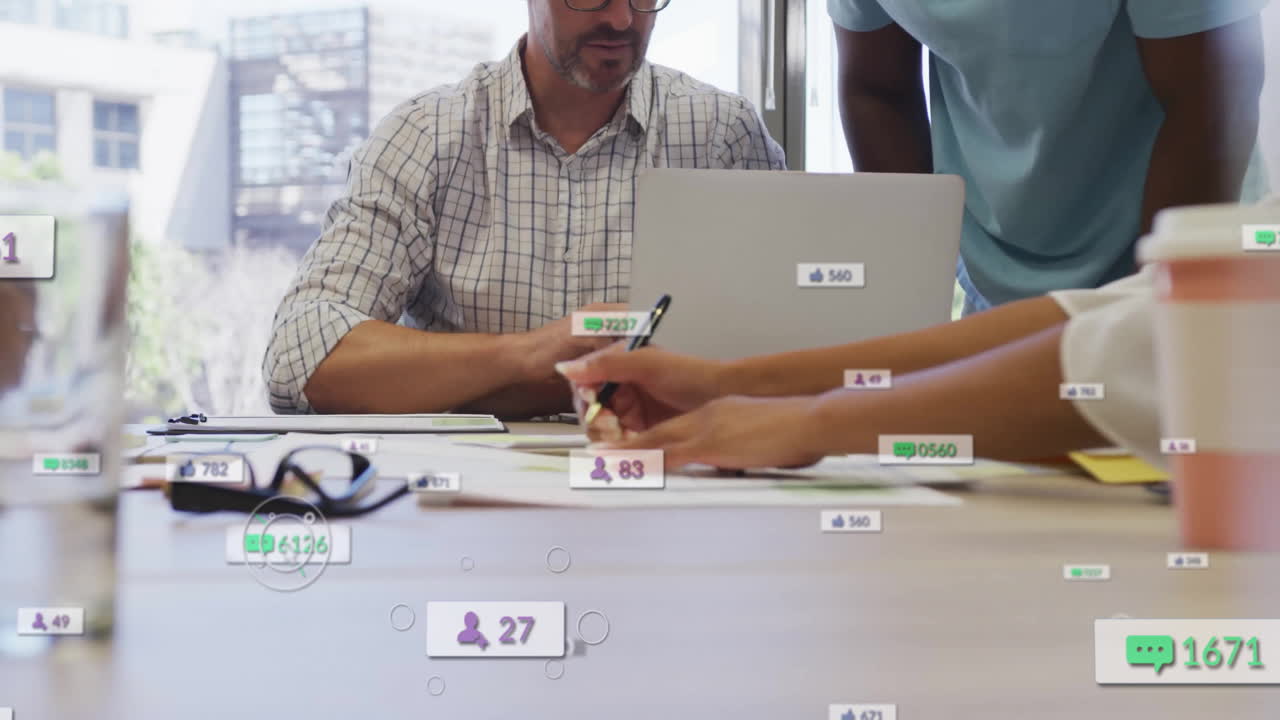 Business team collaborating at desk with social media engagement animation overlay