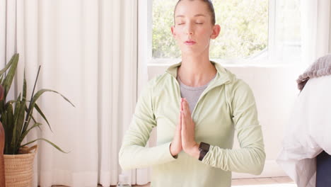 woman meditating at home, eyes closed, finding peace and relaxation