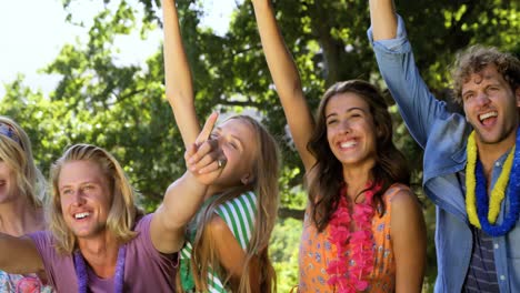 hipster friends raising their arms