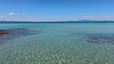 stunning beach scene in halkidiki, greece, with elegant sunbeds facing the crystal-clear turquoise sea. a perfect summer escape in the heart of the aegean.