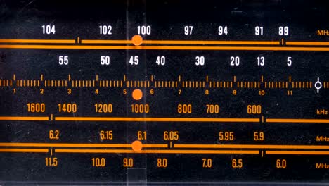 tuning analog radio dial frequency on scale of the vintage receiver