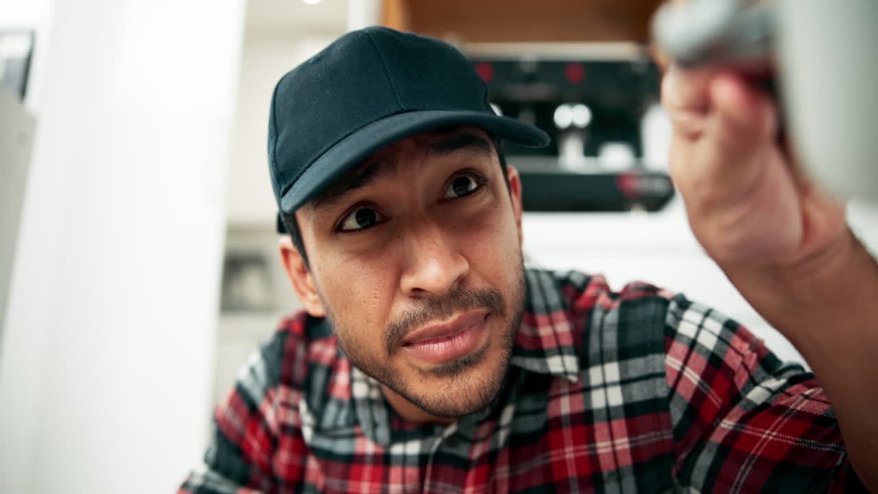 Man in plaid shirt looking up