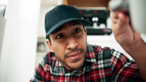 man in plaid shirt looking up