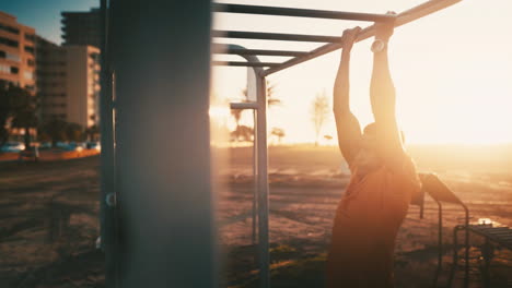 a sporty young man exercising at a calisthenics