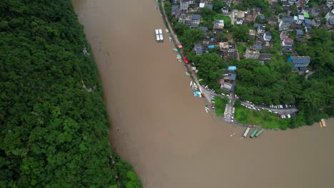 aerial birdseye dolly left of li jiang river with brown and contaminated waters, china