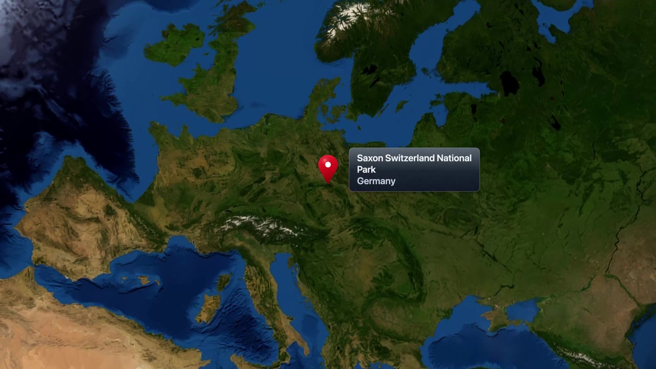 Satellite animation zooms from space into Europe, pinpointing Saxon Switzerland National Park in Germany. Includes NASA public domain imagery.