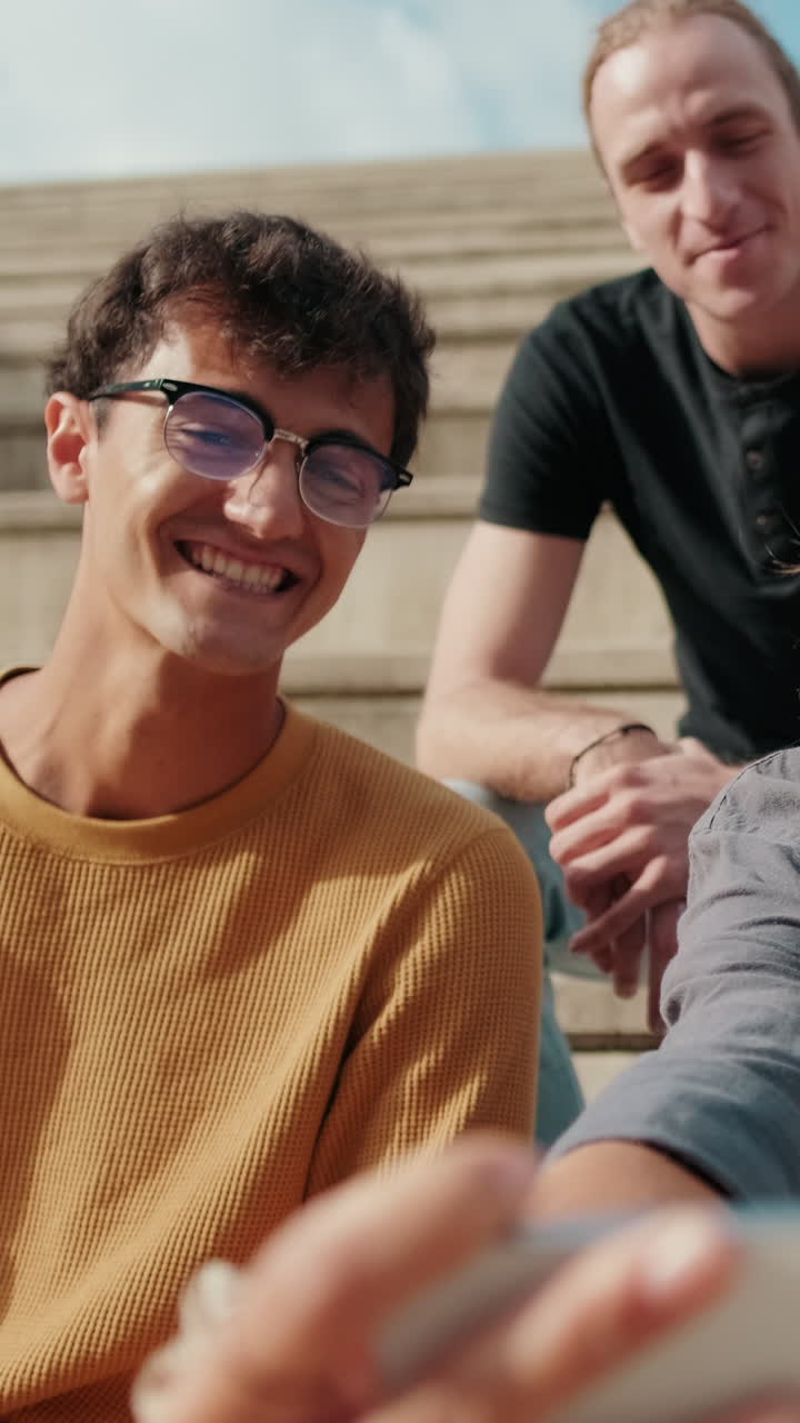 Group of young people taking a selfie or video with their phone