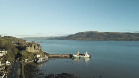 carlingford castle and harbor in county louth, ireland at sunrise, aerial view