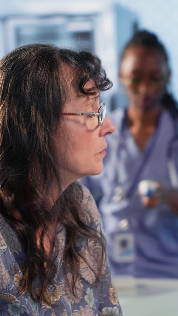 Vertical Video Radiologist discusses an x ray and MRI scan helping a male patient